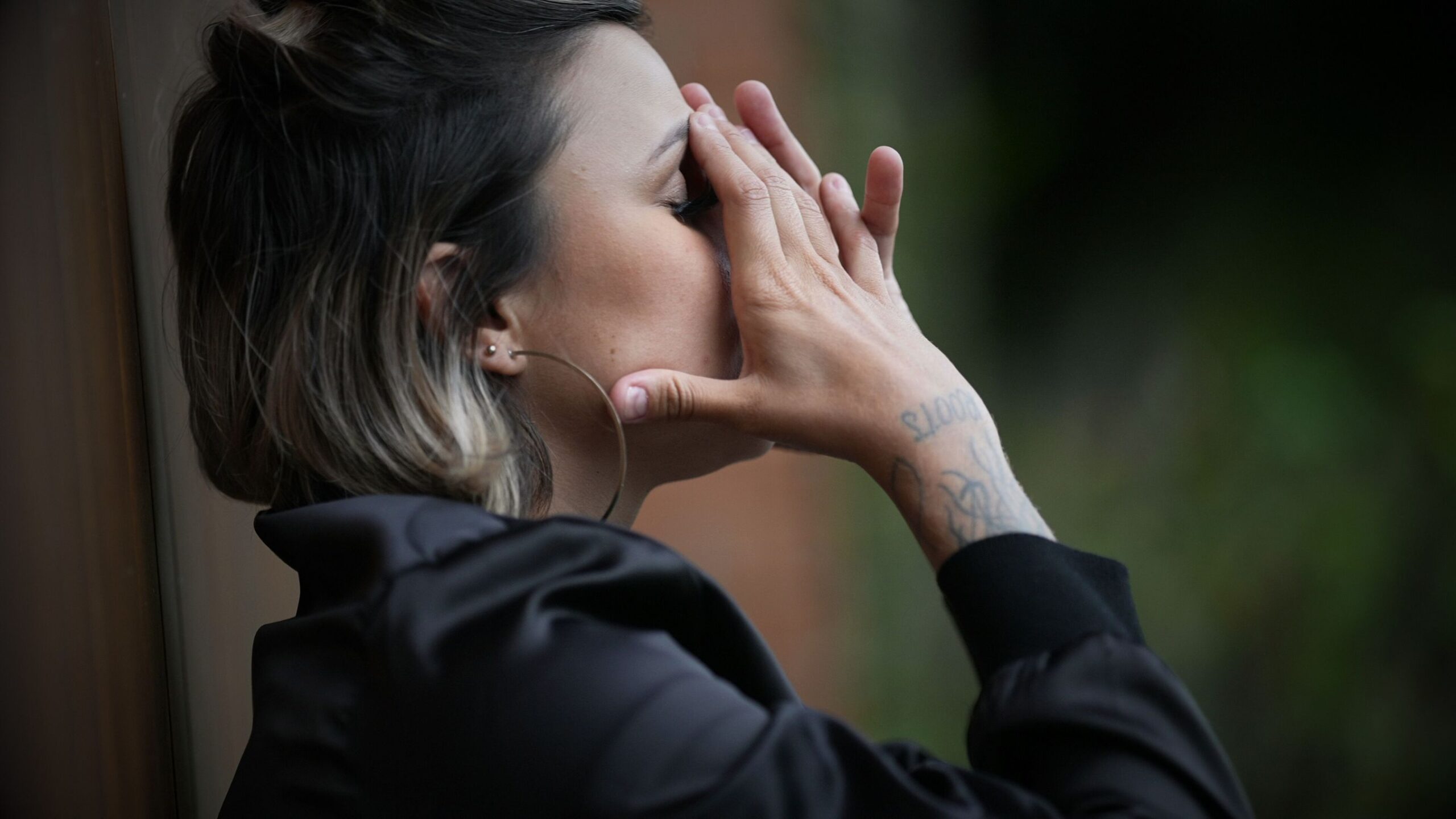 Convicted Driver Woman looking distressed with her hands covering her face, symbolizing the stress of finding specialist insurance.