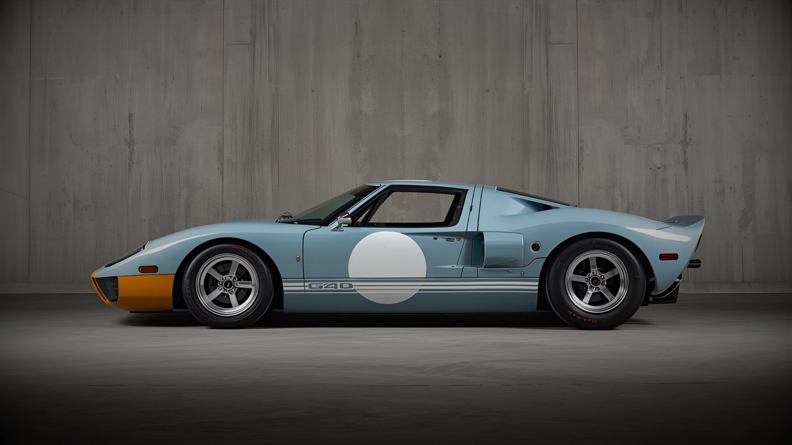 Ford GT40 Side profile of a light blue and orange classic Ford GT40 race car with white circle decals, professionally displayed indoors for secure, discreet storage.