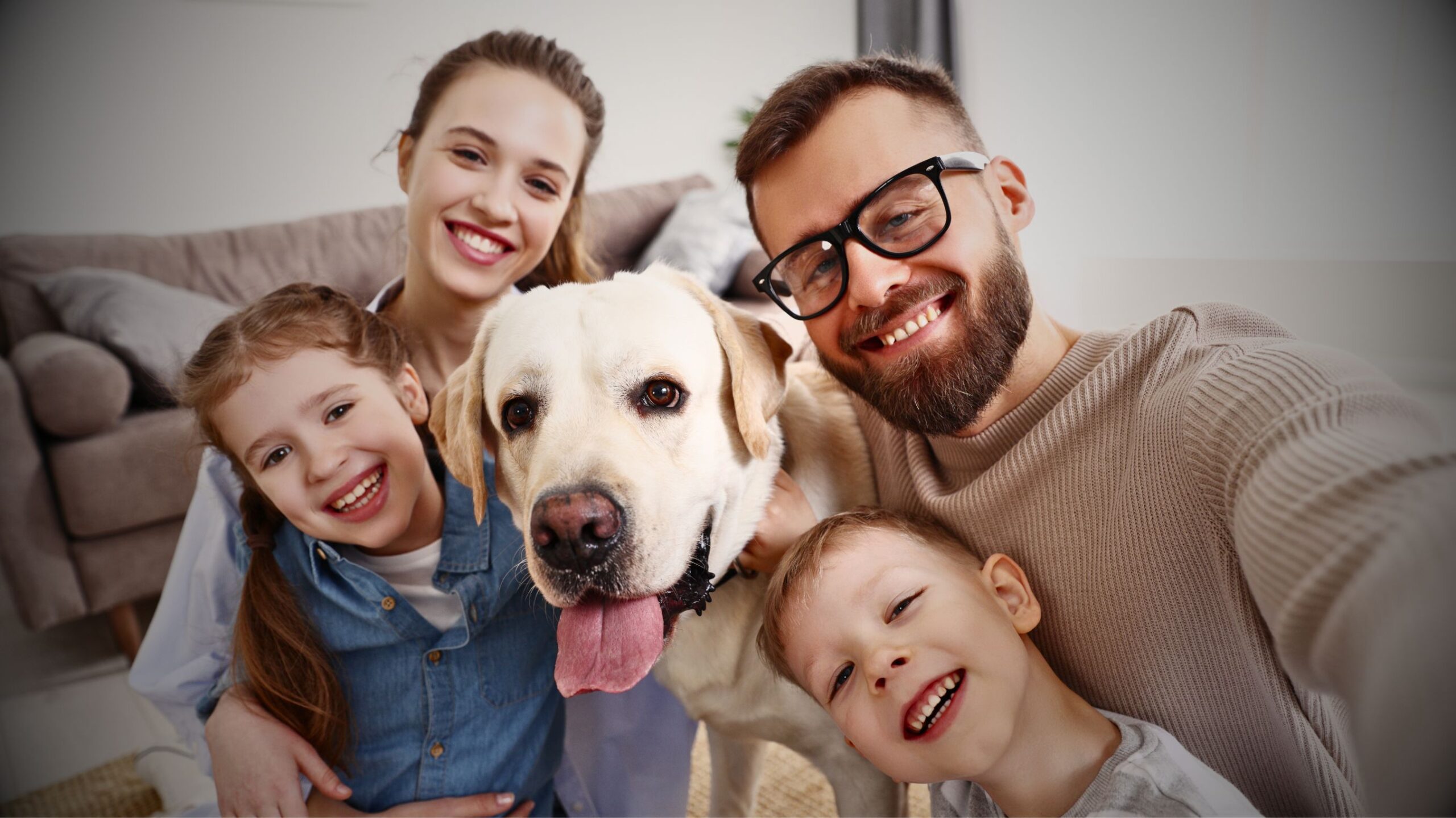 Happy Family Happy family with dog taking a selfie at home, smiling, representing securing their family home through private conveyancing legal services.