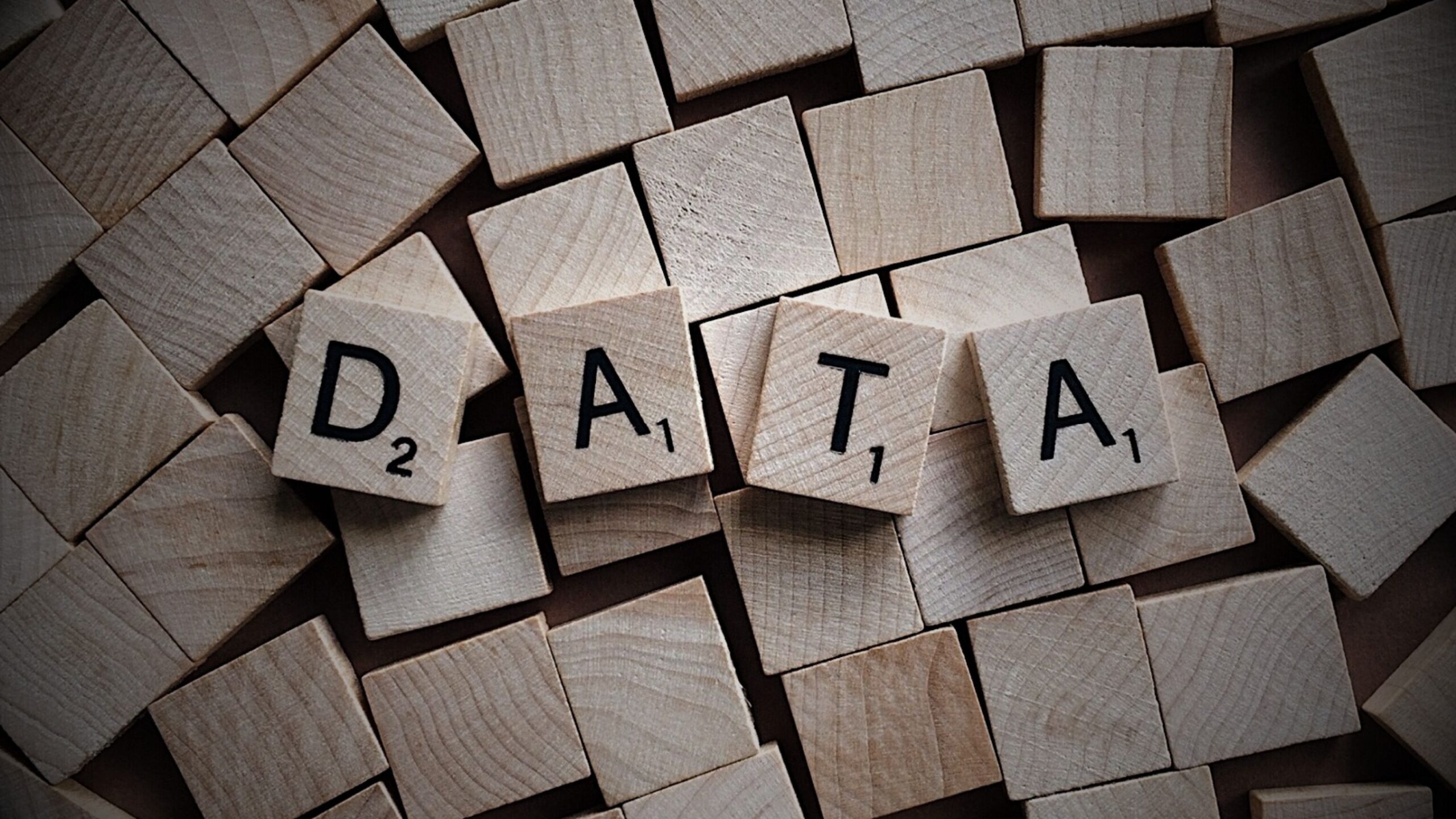 VINTTRO Legal Partner for Data & Privacy Law. Close-up of wooden letter tiles spelling 'DATA', symbolising the crucial legal need for managing, protecting, and ensuring compliance for all corporate data assets.