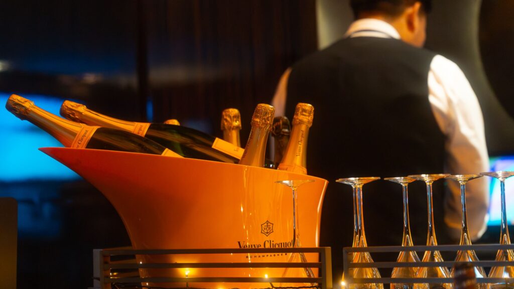 Events and Networking hosted by VINTTRO, showing Bottles of Veuve Clicquot champagne in an orange ice bucket.