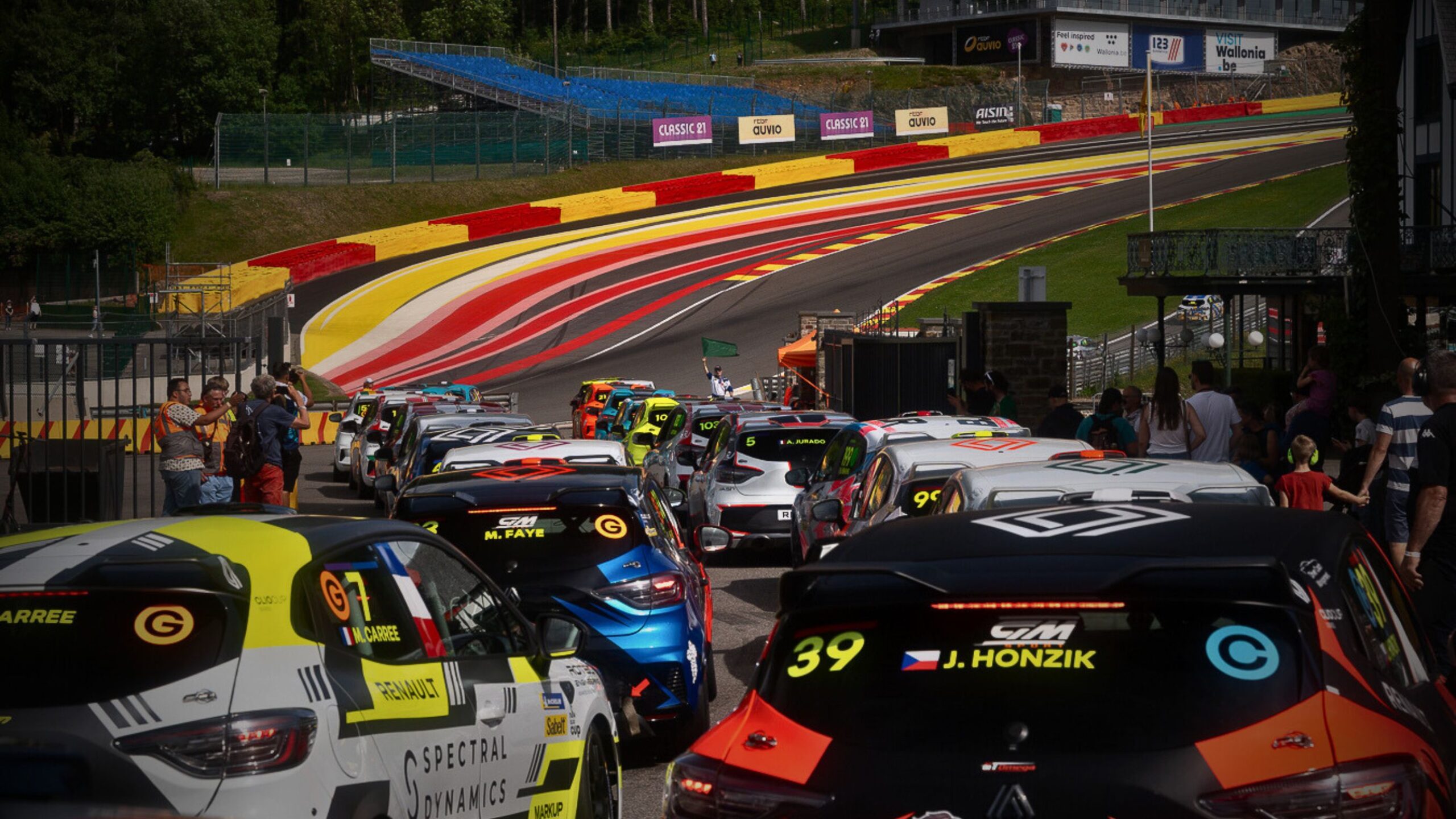 A line of racing cars queued in the pit lane at Spa-Francorchamps circuit photographed at a VINTTRO road trip networking event.