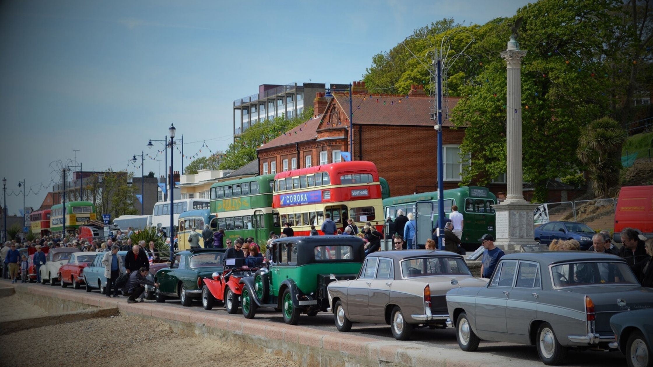Ipswich – Felixstowe Historic Vehicle Run - A line of classic cars and vintage buses, including a red double-decker Corona bus and a green Hadley's bus, parked along the Felixstowe promenade during the Historic Vehicle Run.