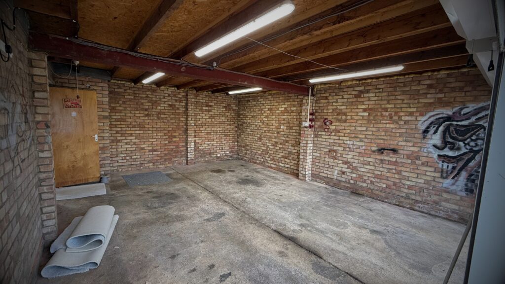 This image shows untidy home garage storage before complete overall to a home showroom created by VINTTRO policyholder Greg.